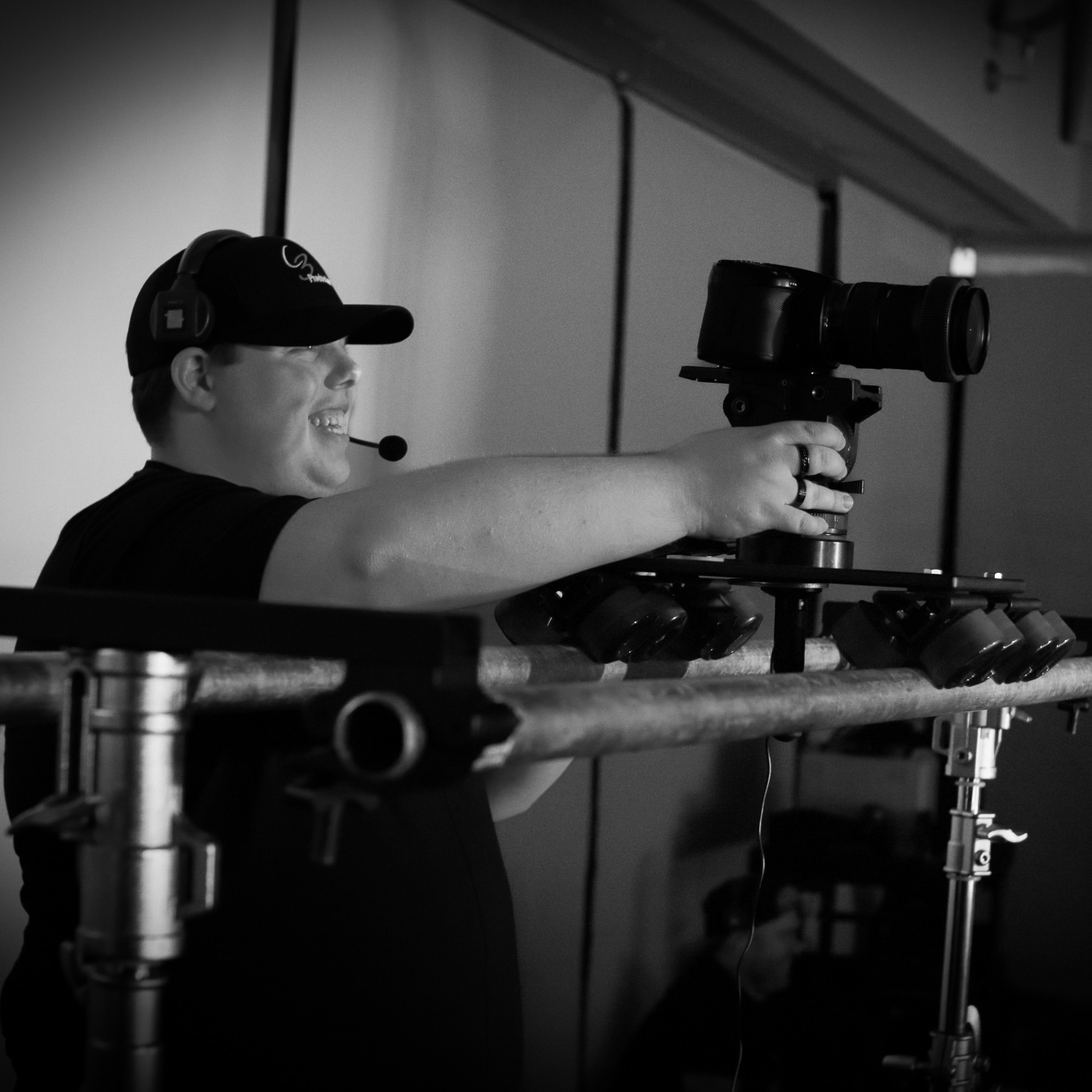 Videographer Clayton Causer operating a camera on a slider during a video production shoot in the Triangle, NC