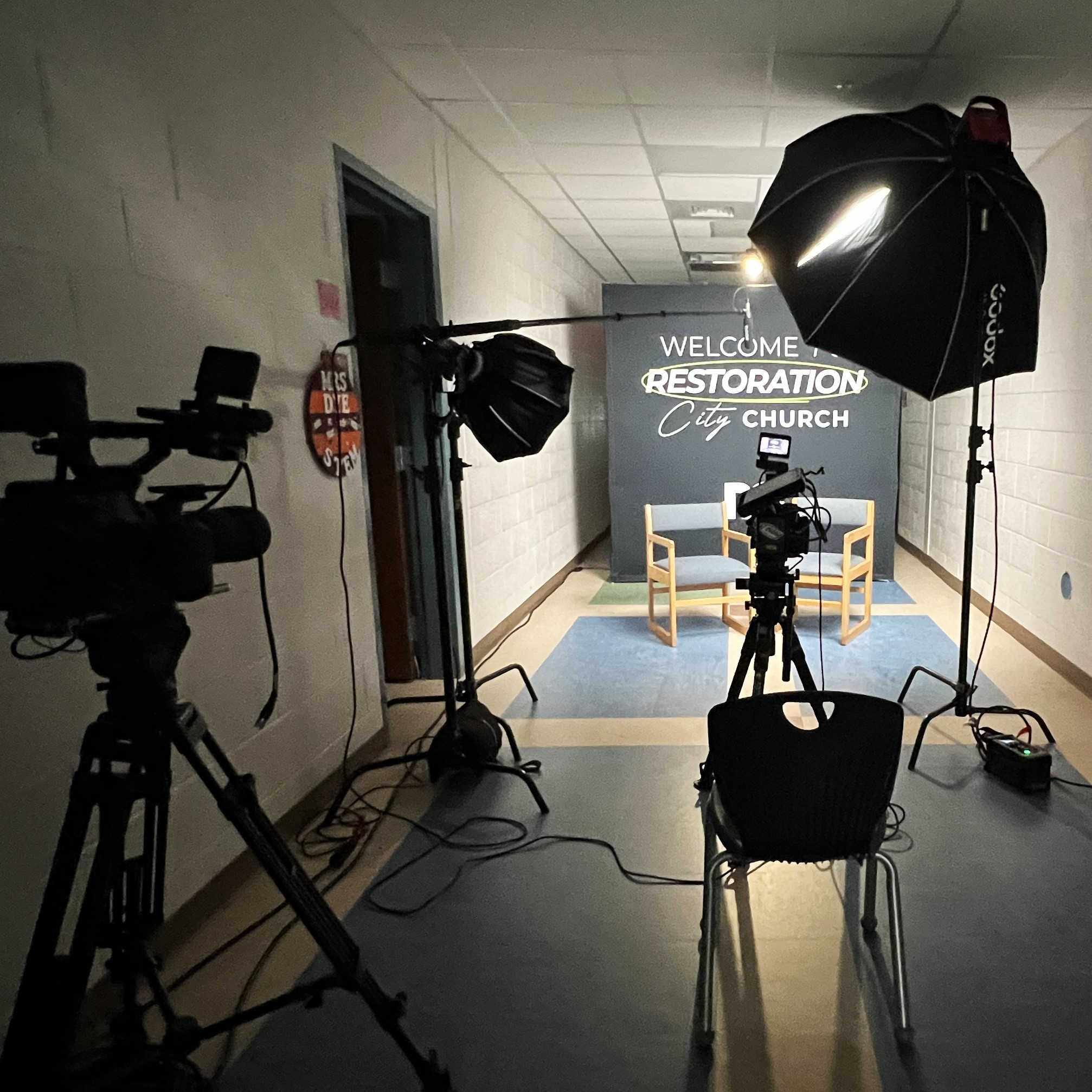 Behind-the-scenes of a C3 Productions interview video set with studio lighting at Restoration City Church, NC