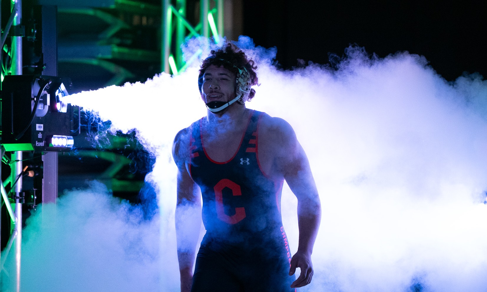 Sports event photography of a Campbell University wrestler entering through stage smoke