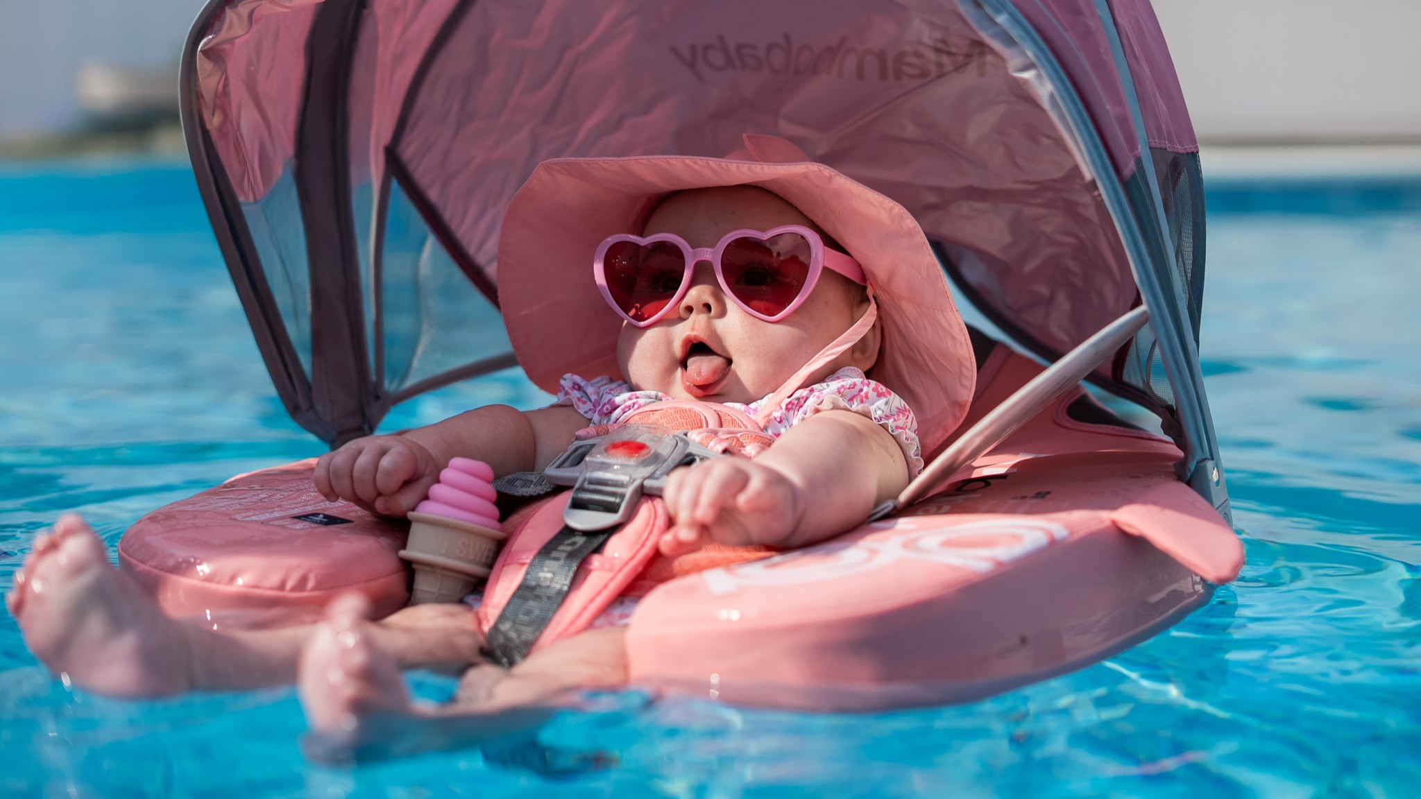 Lifestyle family photography of a child in a swimming pool