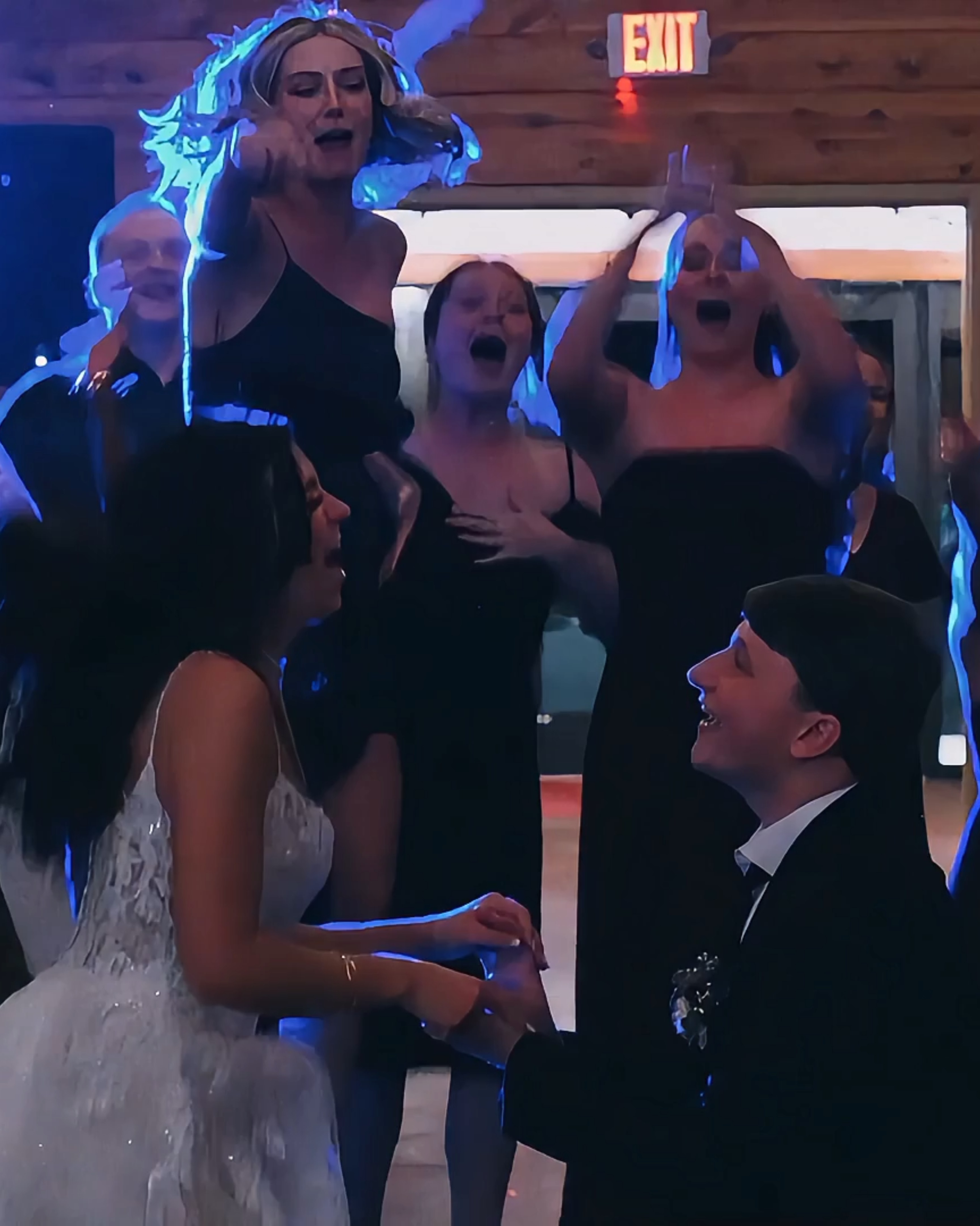 Wedding guests celebrating on the dance floor during the reception