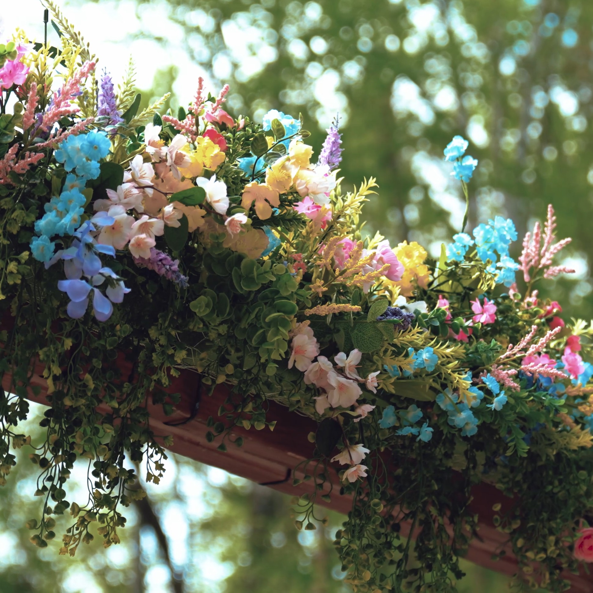 Colorful floral arch decor at an outdoor wedding ceremony