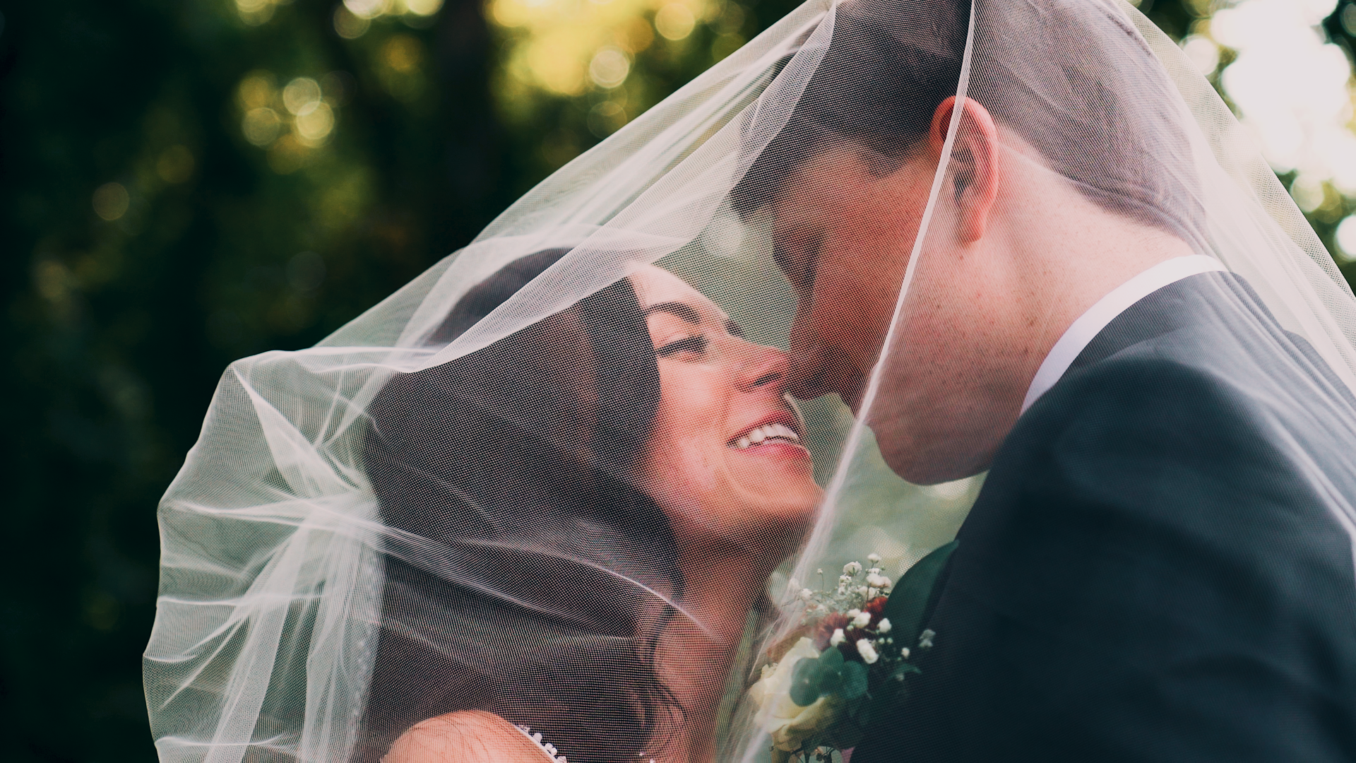 Bride and groom under the veil at an outdoor Triangle, NC wedding